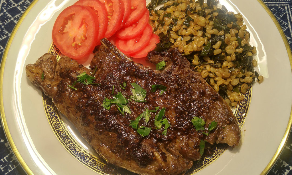 Black Pepper Sauce Lamb served with a barley and kale pilaf and tomatoes