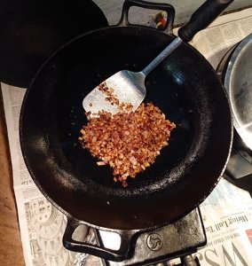 Properly fried onions in a cast iron karhai