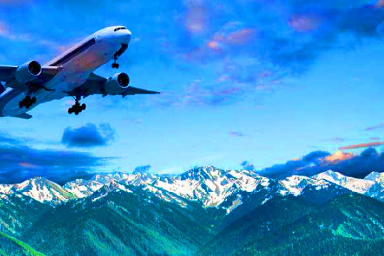 Airliner above snowcapped mountains